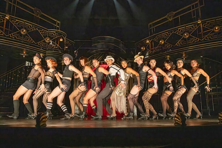 "In here, life is beautiful." These words echo through the transformed walls of London’s Playhouse Theatre, now the immersive, glittering home of the Kit Kat Club — the beating heart of the West End’s groundbreaking revival of Cabaret. With its bold reimagining of one of the most iconic musicals of all time, this production has not only captivated audiences but has redefined what theatre can be.